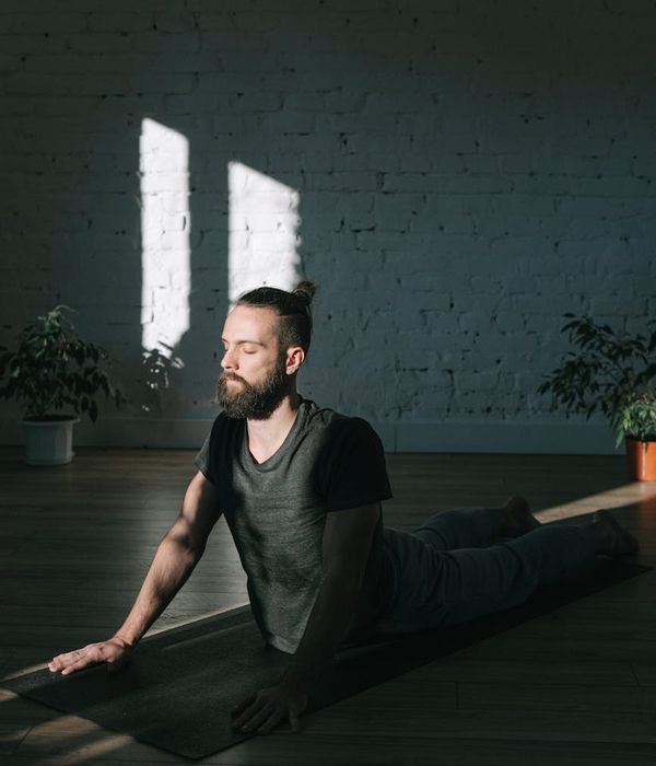 Man focused on a balance exercise in a calm environment.